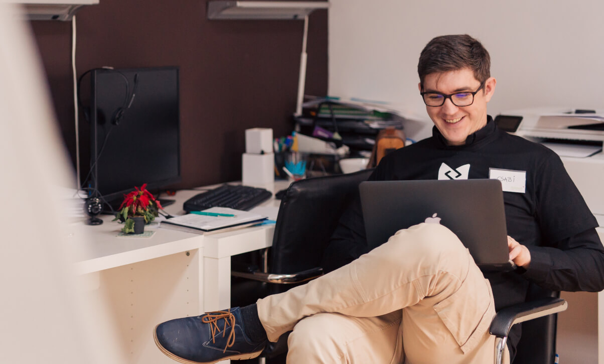 Man with laptop in an office chair