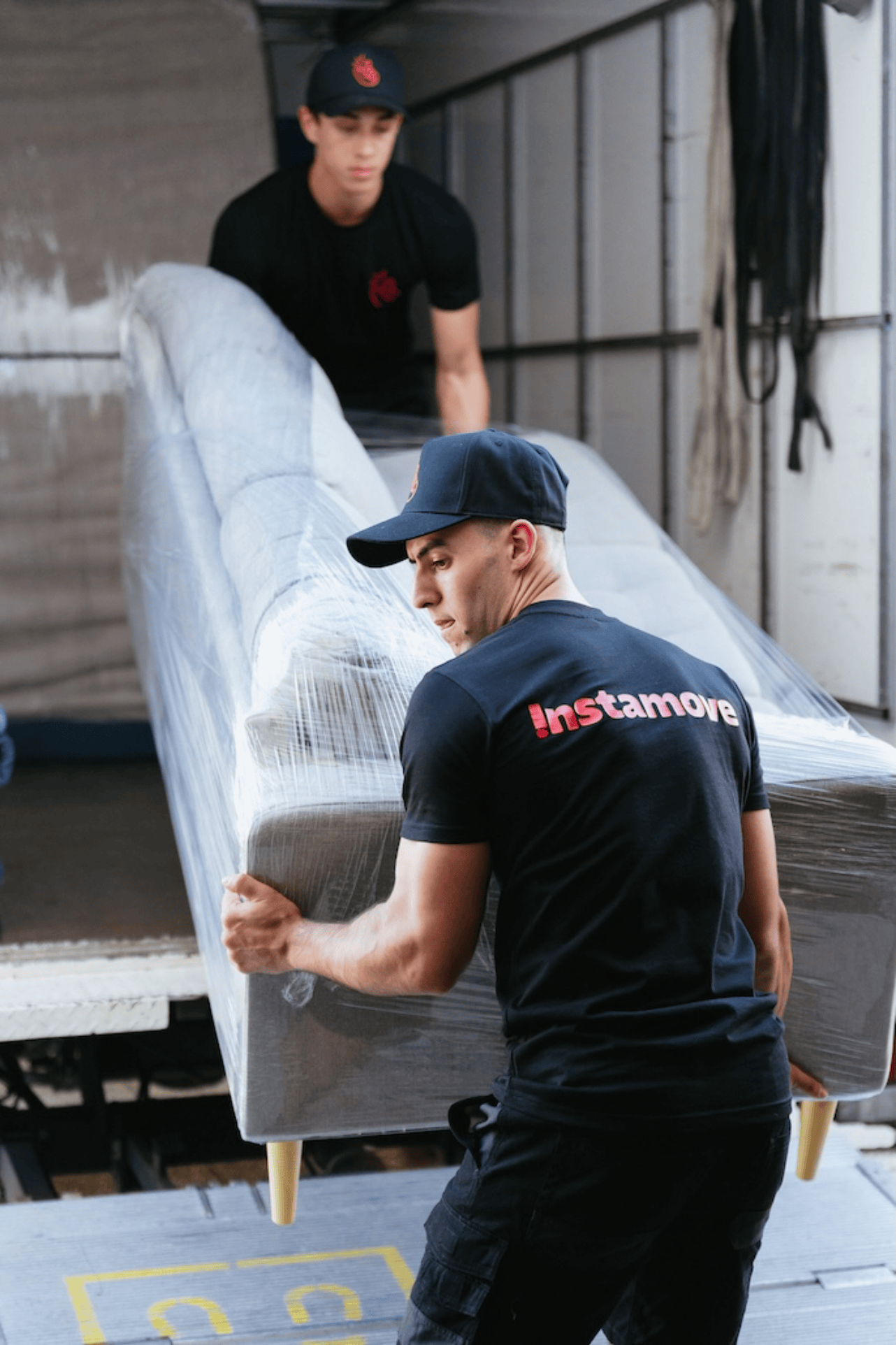 Instamove movers loading a couch